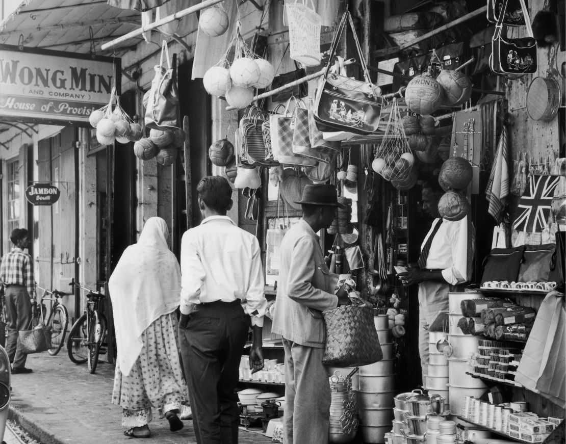 Mauritius circa 1955. Household items are displayed outside an Indian merchant's shop in Port Louis.