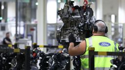 A worker removes a Ford Transit van engine from the conveyor at the Ford Motor Co.s engine assembly plant in Dagenham, U.K., on Monday, Oct. 9, 2017. Chief Executive Officer Jim Hackett pledged accelerated work on green and driverless vehicles, more partnerships and acquisitions, a focus on the trucks and SUVs buyers want, and improved operational fitness. Photographer: Luke MacGregor/Bloomberg via Getty Images