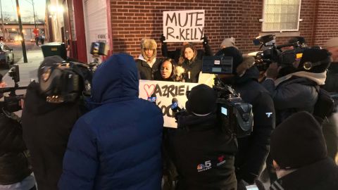 Protesters outside R. Kelly's studio in Chicago call for a boycott of his music. 