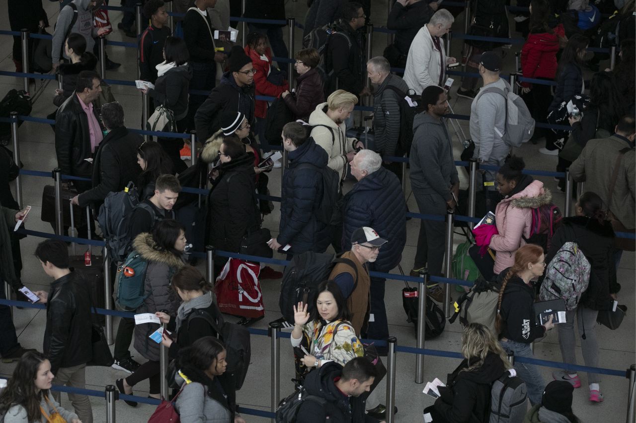 Passengers wait in line at New York's John F. Kennedy International Airport on Monday, January 7.