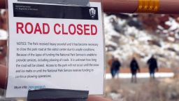 Visitors walk through the visitor center parking lot past a road which is closed because of the partial government shutdown, in Arches National Park, Utah, U.S., January 9, 2019.  REUTERS/George Frey