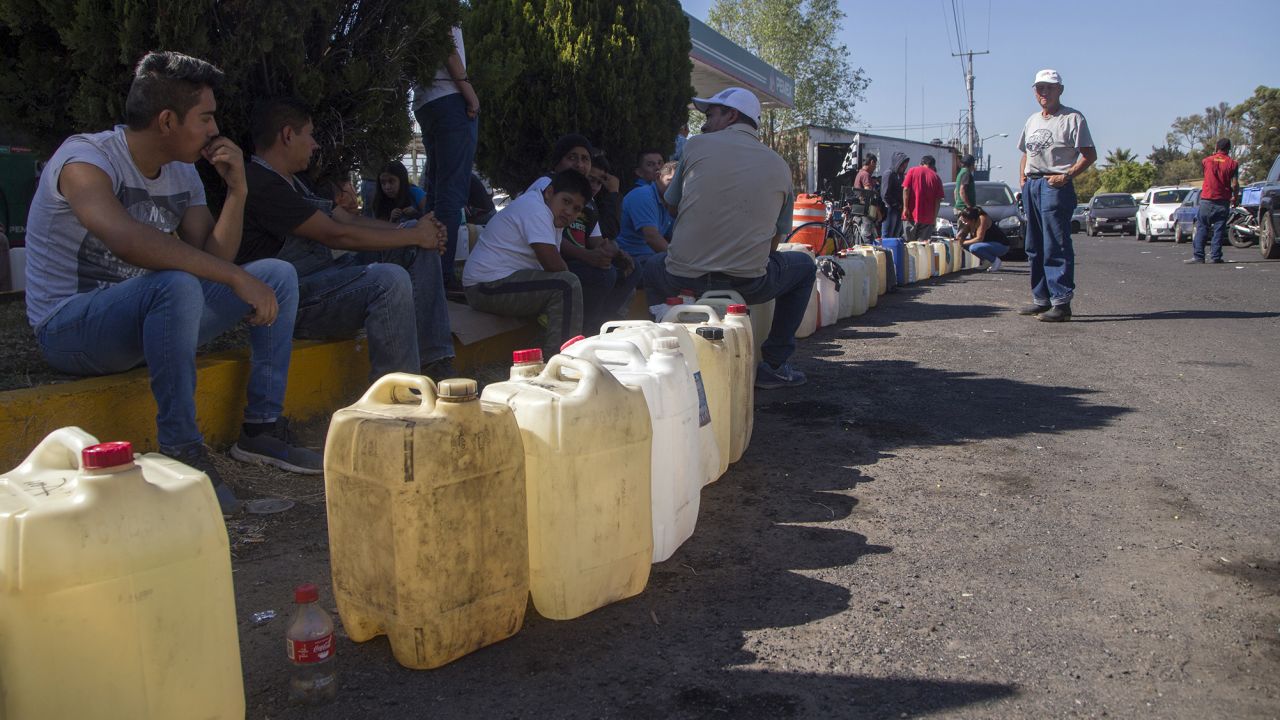 People buy gasoline at a gas station in Mexico's Michoacan state, one of several Mexican states where shortages have been reported, on January 8, 2019.