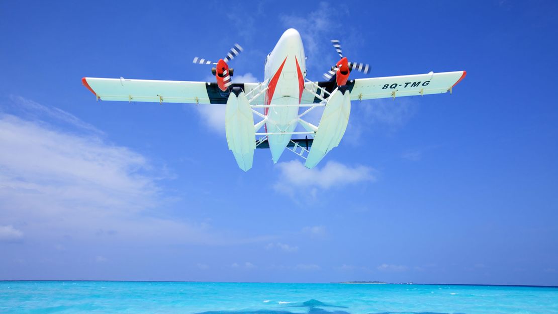 A Trans Maldivian Airways Twin Otter takes off from its watery runway. 