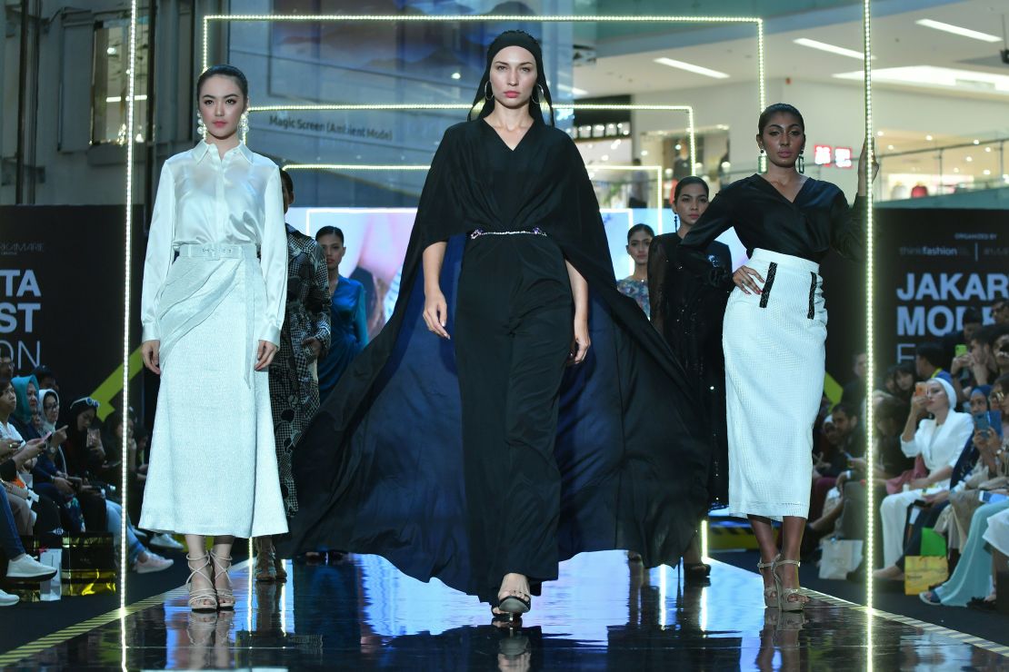 Indonesian models present creations by Russian designer Araida during 2018's Jakarta Modest Fashion Week.