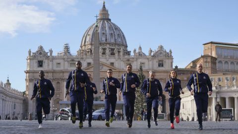 Members of the Athletica Vaticana sports team run in front of St. Peter's Basilica on Thursday.