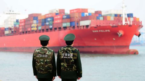Police officers watching a cargo ship at a port in Qingdao in 2018. China's official growth rate for last year is expected to be around 6.5%, the weakest in nearly three decades.