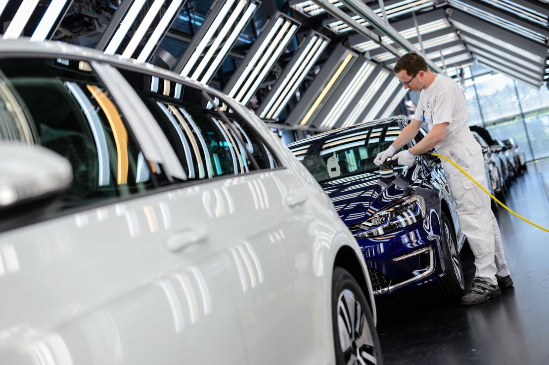 An employee polishes an e-Golf electric inside the Volkswagen factory in Dresden, Germany. 