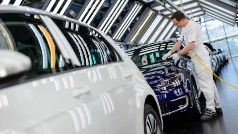 An employee polishes an e-Golf electric inside the Volkswagen factory in Dresden, Germany.