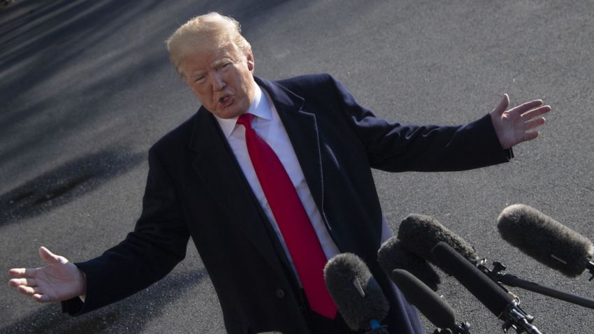 US President Donald Trump speaks as he departs the White House in Washington, DC, on January 6, 2019, for meetings at Camp David. - President Donald Trump stood firm Sunday on his demand for billions of dollars to fund a border wall with Mexico, which has forced a shutdown of the US government now entering its third week."We have to build the wall," Trump told reporters as he left the  White House for the Camp David presidential retreat, while  conceding that the barrier could be "steel instead of concrete." (Photo by Jim WATSON / AFP)        (Photo credit should read JIM WATSON/AFP/Getty Images)