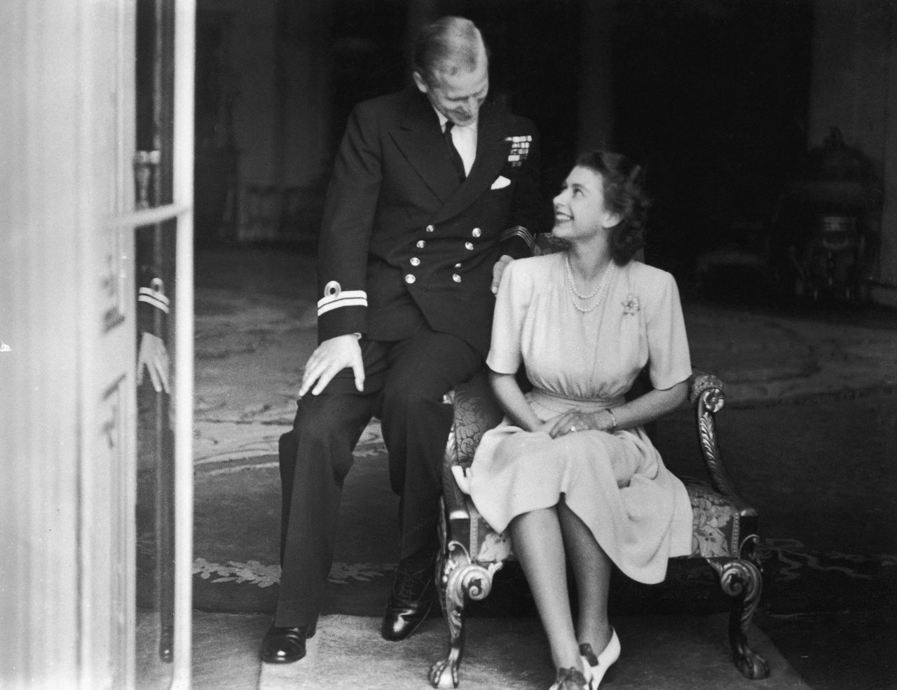 Prince Philip sits with his fiancee, Princess Elizabeth, in July 1947. He had become a naturalized British citizen and a commoner, using the surname Mountbatten, an English translation of his mother's maiden name. He was also an officer of the British Royal Navy and fought in World War II.