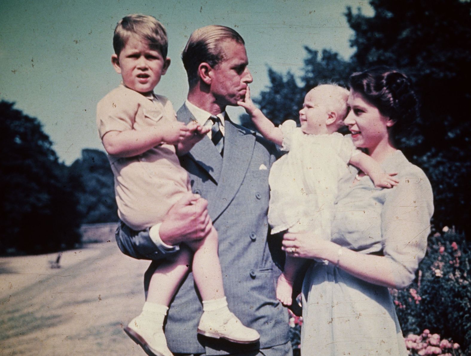 Philip and Elizabeth hold their children Prince Charles and Princess Anne in August 1951.