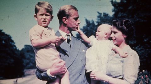 Philip and Elizabeth hold their children Prince Charles and Princess Anne in August 1951.