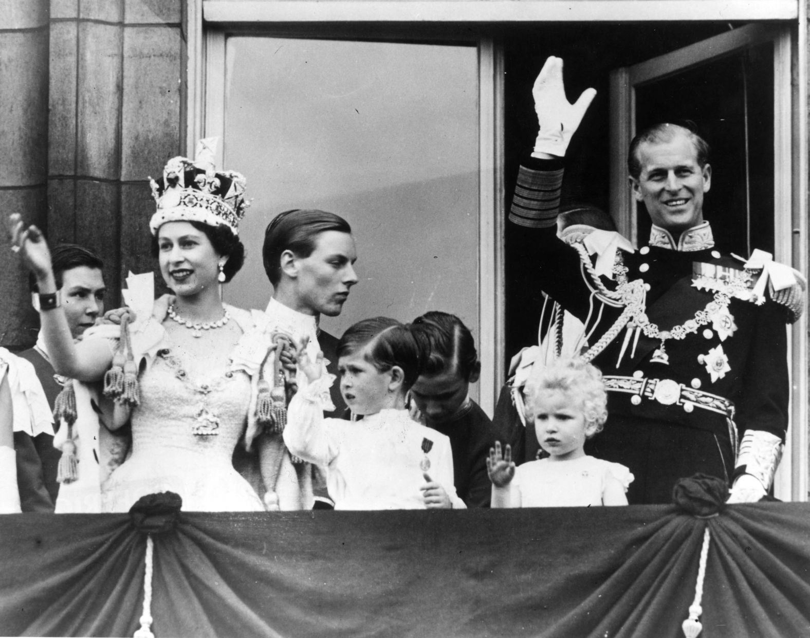 Prince Philip waves from the balcony of Buckingham Palace after his wife's coronation in June 1953.