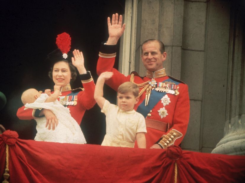 The Queen and Prince Philip, accompanied by sons Prince Andrew and Prince Edward, wave from a Buckingham Palace balcony during a parade in June 1964.