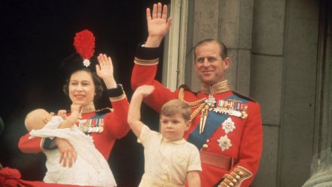 The Queen and Prince Philip, accompanied by sons Prince Andrew and Prince Edward, wave from a Buckingham Palace balcony during a parade in June 1964.