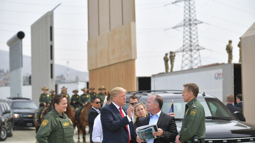 US President Donald Trump (C) is shown border wall prototypes in San Diego, California on March 13, 2018. / AFP PHOTO / MANDEL NGAN        (Photo credit should read MANDEL NGAN/AFP/Getty Images)