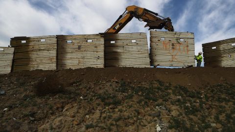 A construction crew works to replace an old section of the U.S.-Mexico border fence on January 11, 2019, as seen from Tijuana, Mexico.