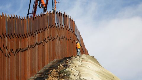 TIJUANA, MEXICO - JANUARY 11: A construction crew works as new sections of the U.S.-Mexico border barrier are installed on January 11, 2019 as seen from Tijuana, Mexico. President Donald Trump is holding off from a threatened national emergency declaration to fund a border wall amidst the partial government shutdown. (Photo by Mario Tama/Getty Images)