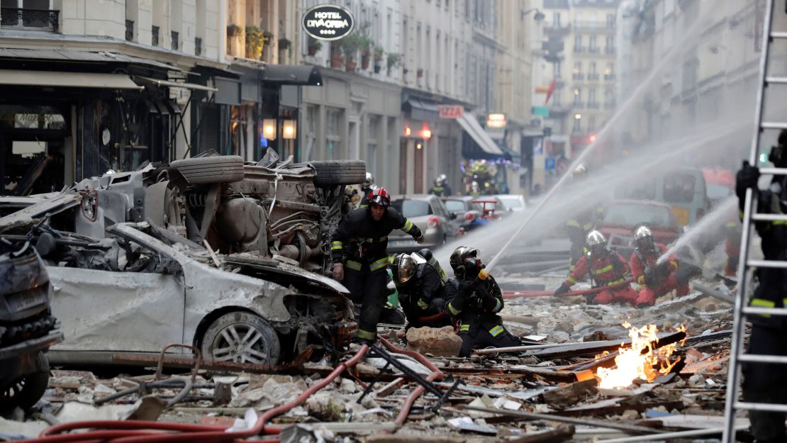 Firefighters intervene after the explosion of a bakery on the corner of the streets Saint-Cecile and Rue de Trevise in central Paris on January 12, 2019.