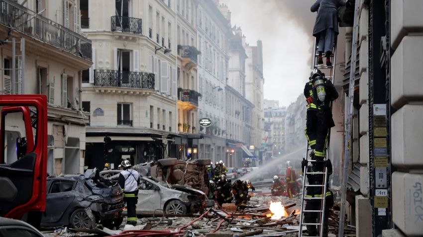 A woman is evacuated by firefighters from an apartment after the explosion of a bakery on the corner of the streets Saint-Cecile and Rue de Trevise in central Paris on January 12, 2019. - A large explosion badly damaged a bakery in central Paris, injuring several people and smashing windows in surrounding buildings, police and AFP journalists at the scene said. A fire broke out after the blast at around 9am (0800 GMT) in the busy 9th district of the city, which police suspect may have been caused by a gas leak. (Photo by Thomas SAMSON / AFP)        (Photo credit should read THOMAS SAMSON/AFP/Getty Images)
