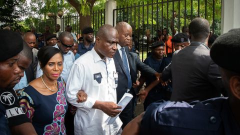 Martin Fayulu, center, leaves court Saturday in Kinshasa with his wife, Esther, after filing an appeal.