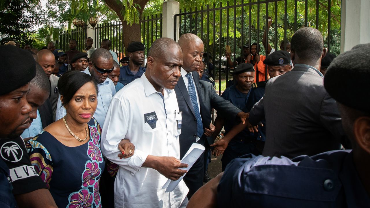 Martin Fayulu, center, leaves court Saturday in Kinshasa with his wife, Esther, after filing an appeal.