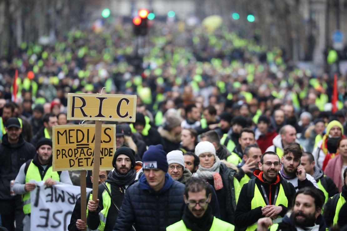 Gilets jaunes (yellow vest) protesters march through Paris on Saturday, hours after the blast that killed two firefighters.