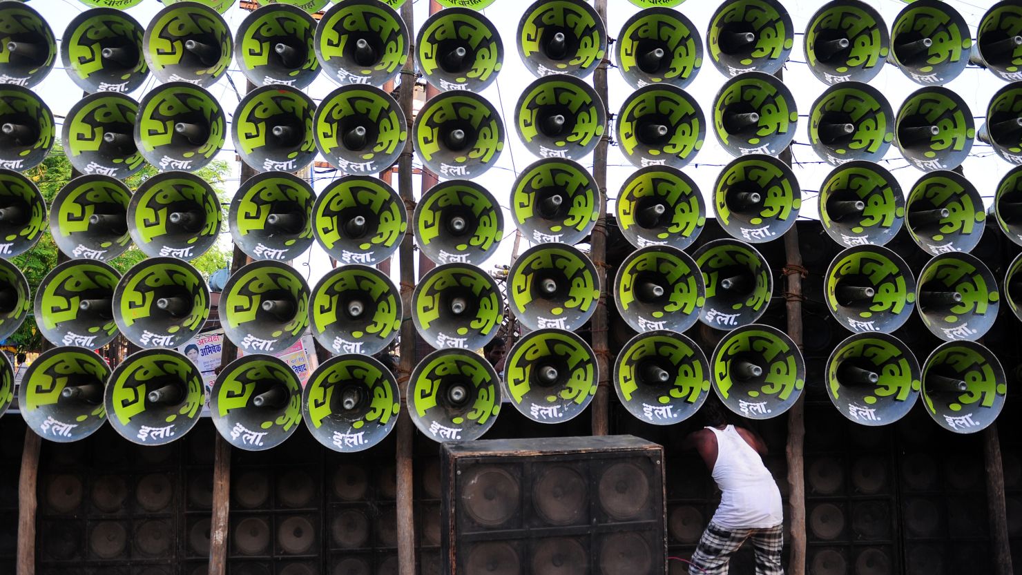 An Indian electrician arranges loudspeakers during a music festival in the city of Prayagraj. 