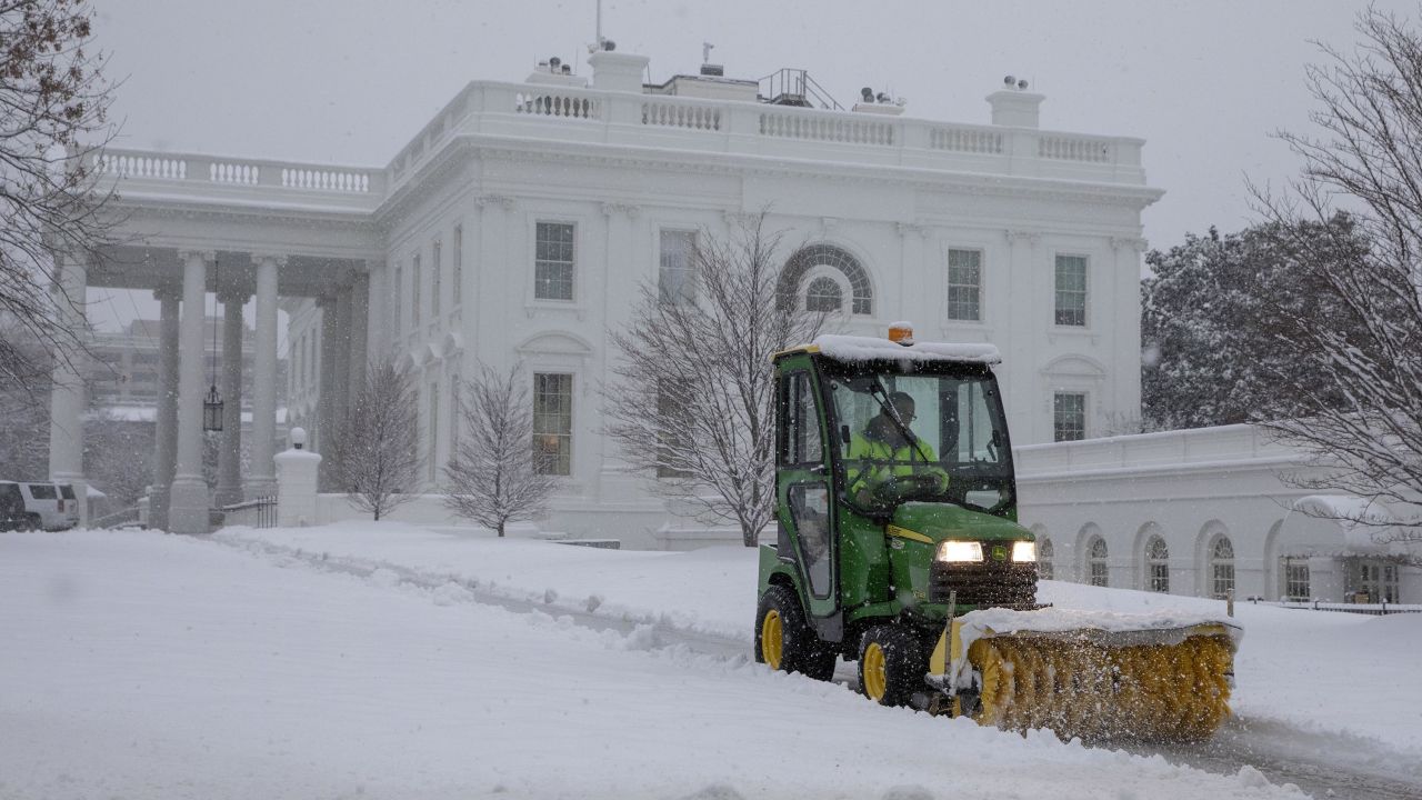 US National Park Service workers clear snow outside the White House.