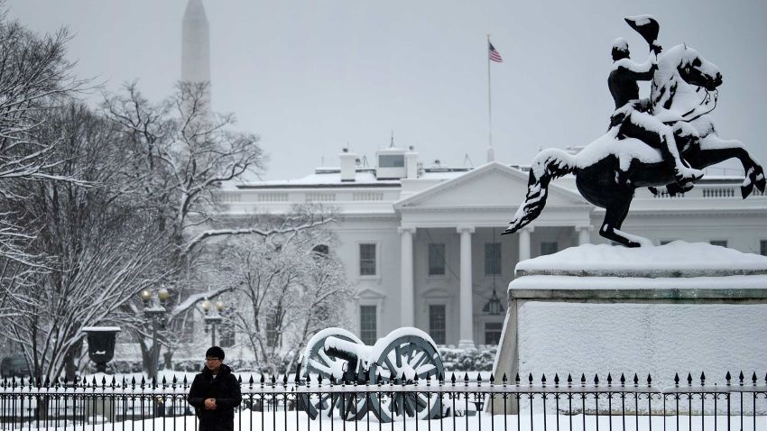 A tourist poses for a photo in Lafayette Square near the White House during a winter storm on the 23rd day of the US government shutdown January 13, 2019 in Washington, DC. - Washington area residents woke up to a winter wonderland, and may need to shovel aside several inches of snow that fell overnight as a winter storm warning remains in effect until 6 p.m. Sunday and more snow is expected to fall. (Photo by Brendan Smialowski / AFP)        (Photo credit should read BRENDAN SMIALOWSKI/AFP/Getty Images)