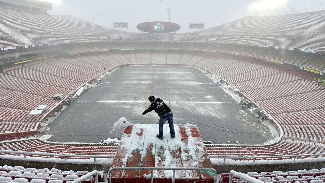 Kyle Haraugh of NFL Films clears snow from a camera location at Arrowhead Stadium on Sunday, January 13, 2019, in Kansas City, Missouri.