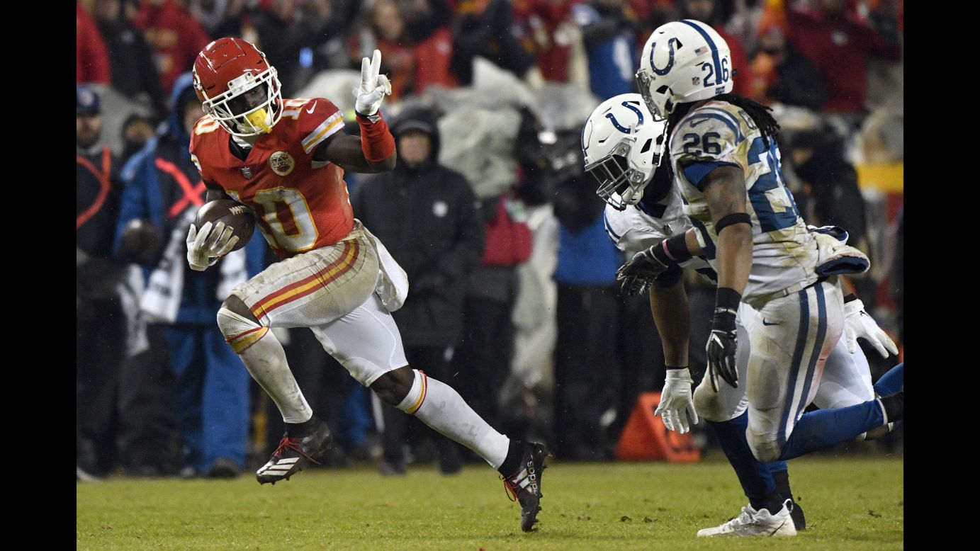 Kansas City Chiefs wide receiver Tyreek Hill runs past Indianapolis Colts safety Clayton Geathers and linebacker Anthony Walker during the second half of an NFL divisional football playoff game in Kansas City, Missouri, on January 12.