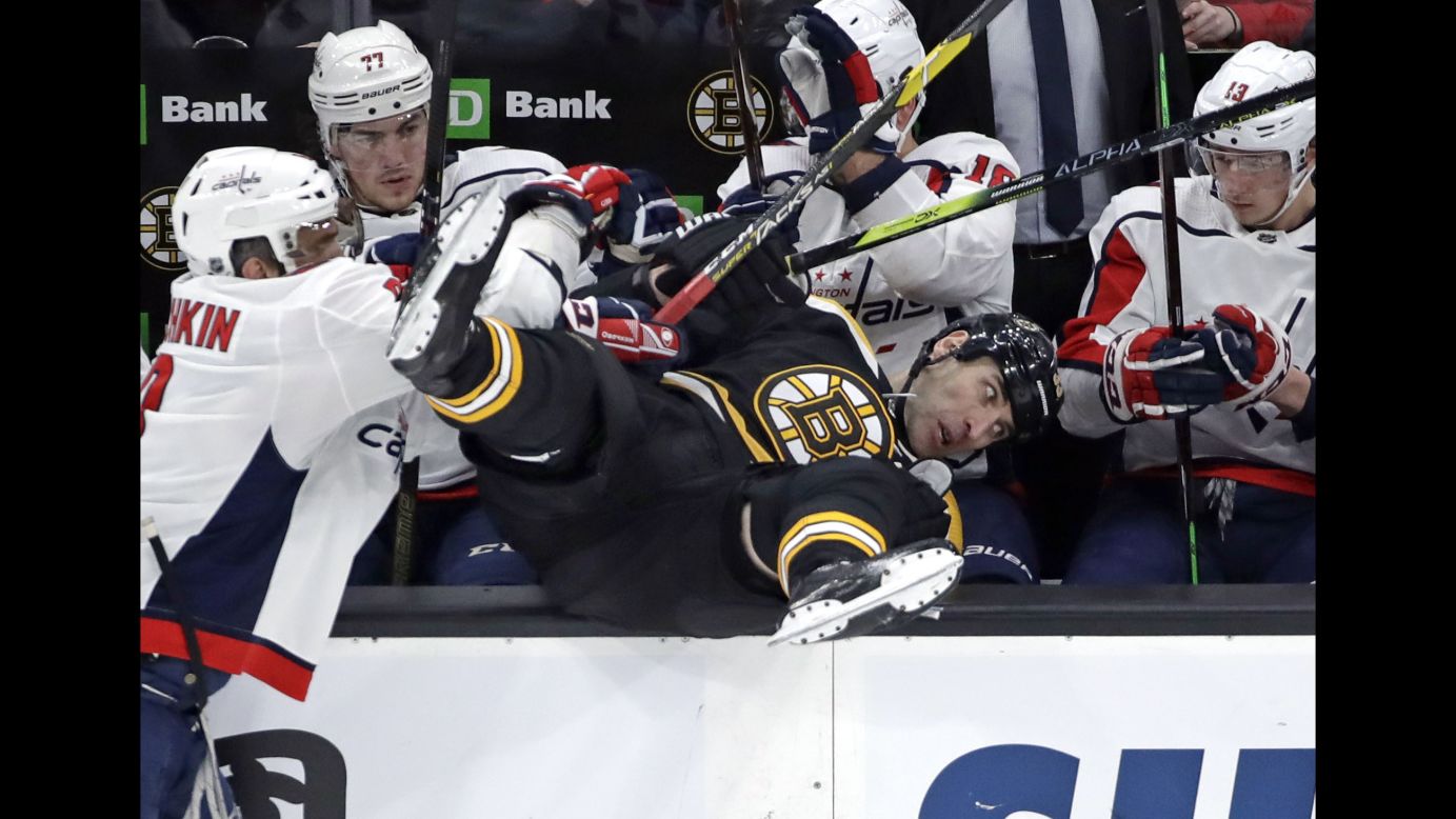 Boston Bruins defenseman Zdeno Chara is checked into the Washington Capitals bench by Washington Capitals left wing Alex Ovechkin, left, during the first period of an NHL hockey game in Boston on January 10.