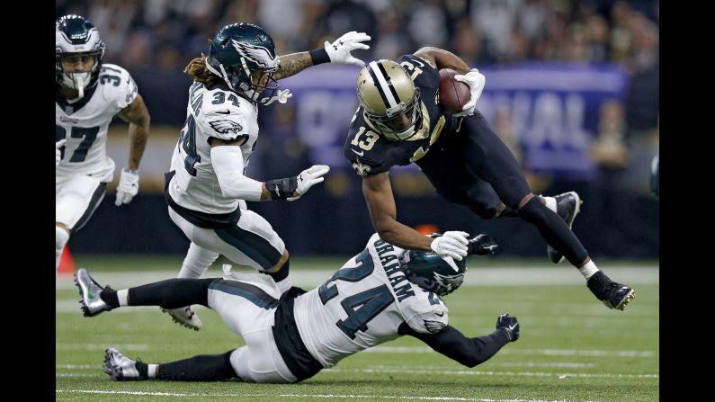 Michael Thomas of the New Orleans Saints is tripped up by Corey Graham of the Philadelphia Eagles during the first quarter in the NFC Divisional Playoff Game at Mercedes Benz Superdome in New Orleans on January 13.