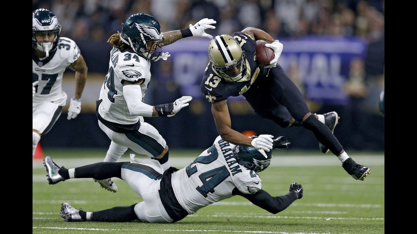 Michael Thomas of the New Orleans Saints is tripped up by Corey Graham of the Philadelphia Eagles during the first quarter in the NFC Divisional Playoff Game at Mercedes Benz Superdome in New Orleans on January 13.