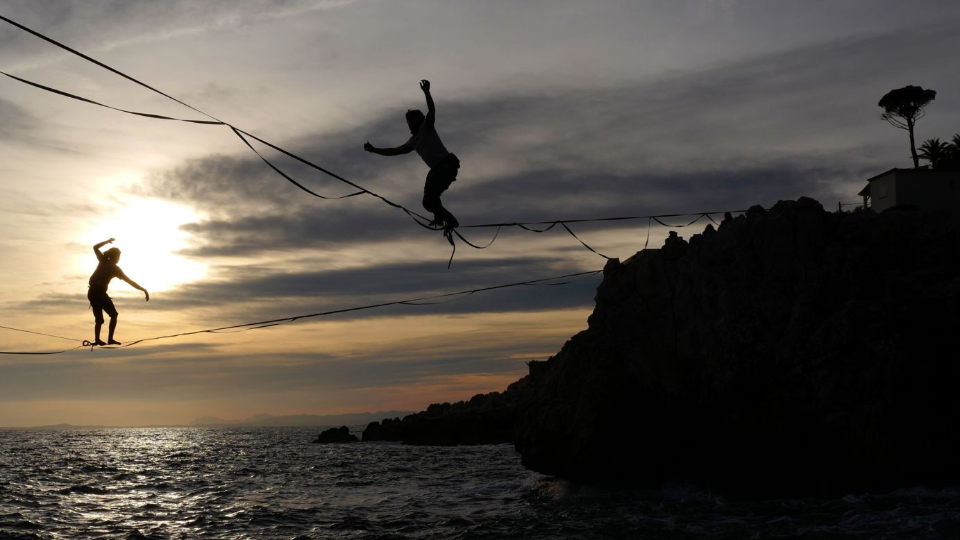Men walk on a tightrope above the sea at sunset in Nice, France, on January 13.