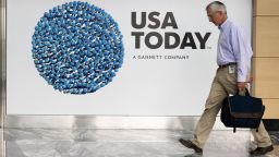 A man walks through the lobby of the Gannett-USA Today headquarters in McLean, Virginia, on August 20, 2013.