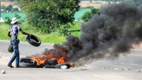 A protester burns tires on a road in Emakhandeni township, Bulawayo. during a demonstration against the doubling of fuel prices in Zimbabwe.