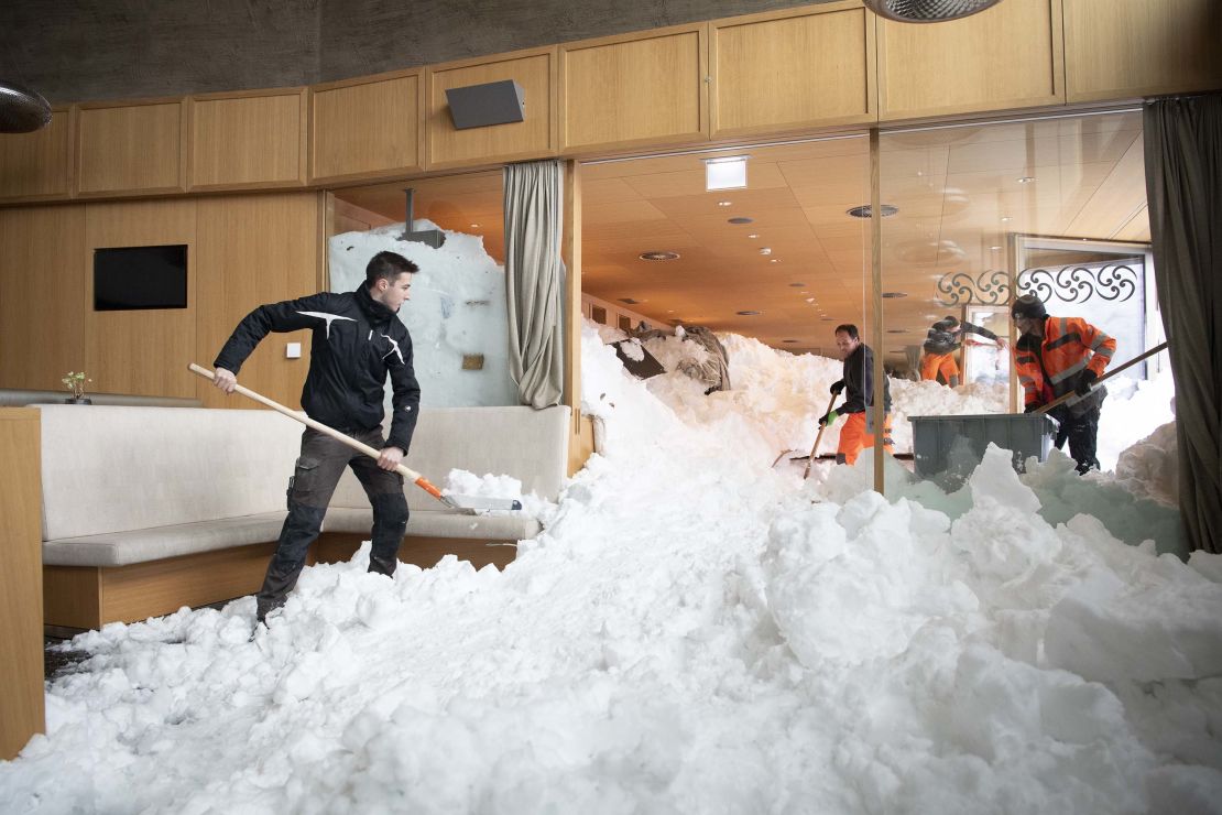 Emergency service workers clear snow from the inside a hotel on the Schwaegalp, Switzerland, after an avalanche.