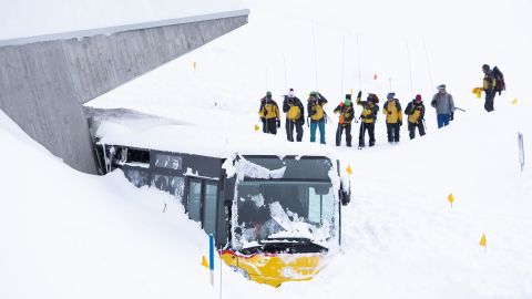 Search and rescue workers dig out a bus caught by an avalanche in Hundwil, Switzerland.