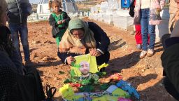 The family of 27-year-old Mahmoud Rassoul grieve by his grave in Kobani, northern Syria.