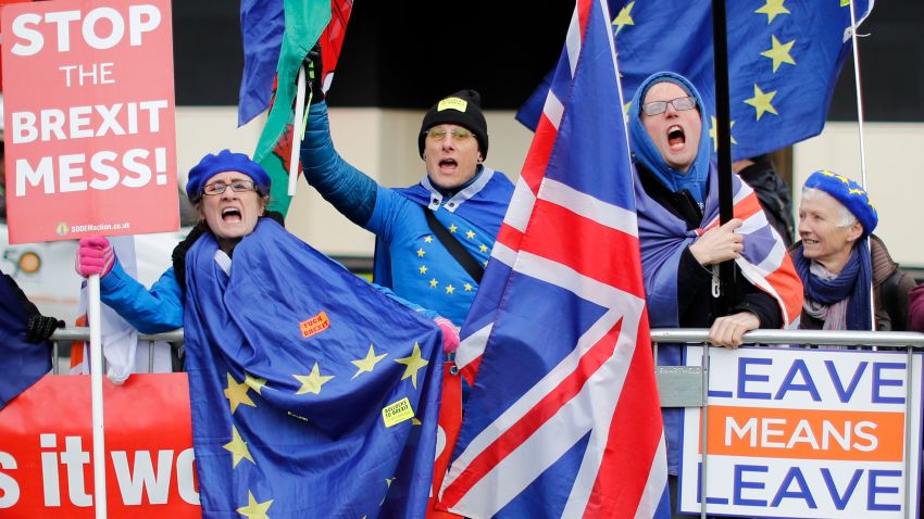 Anti-Brexit supporters hold placards and flags as they demonstrate outside the Houses of Parliament on January 14, 2019. - Prime Minister Theresa May ramped up warnings today to MPs poised to reject her EU divorce deal that failing to deliver Brexit would be "catastrophic" for British democracy. (Photo by Tolga AKMEN / AFP)        (Photo credit should read TOLGA AKMEN/AFP/Getty Images)