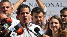 Venezuela's National Assembly president Juan Guaido, accompanied by his wife Fabiana Rosales gestures before a crowd of opposition supporters during an open meeting in Caraballeda, Vargas State, Venezuela, on January 13, 2019. - The president of the opposition-controlled but sidelined National Assembly was released less than an hour after being arrested by Venezuelan intelligence agents on Sunday, his wife said. Guaido had directly challenged the legitimacy of Nicolas Maduro as the president was sworn in for a second term on Thursday, calling for a transitional government ahead of new elections. (Photo by Yuri CORTEZ / AFP)        (Photo credit should read YURI CORTEZ/AFP/Getty Images)