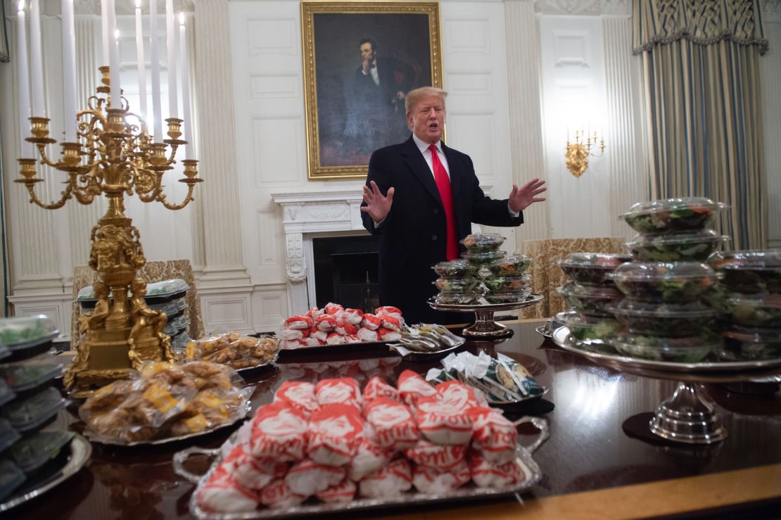 US President Donald Trump speaks alongside fast food he purchased for a ceremony honoring the 2018 College Football Playoff National Champion Clemson Tigers.