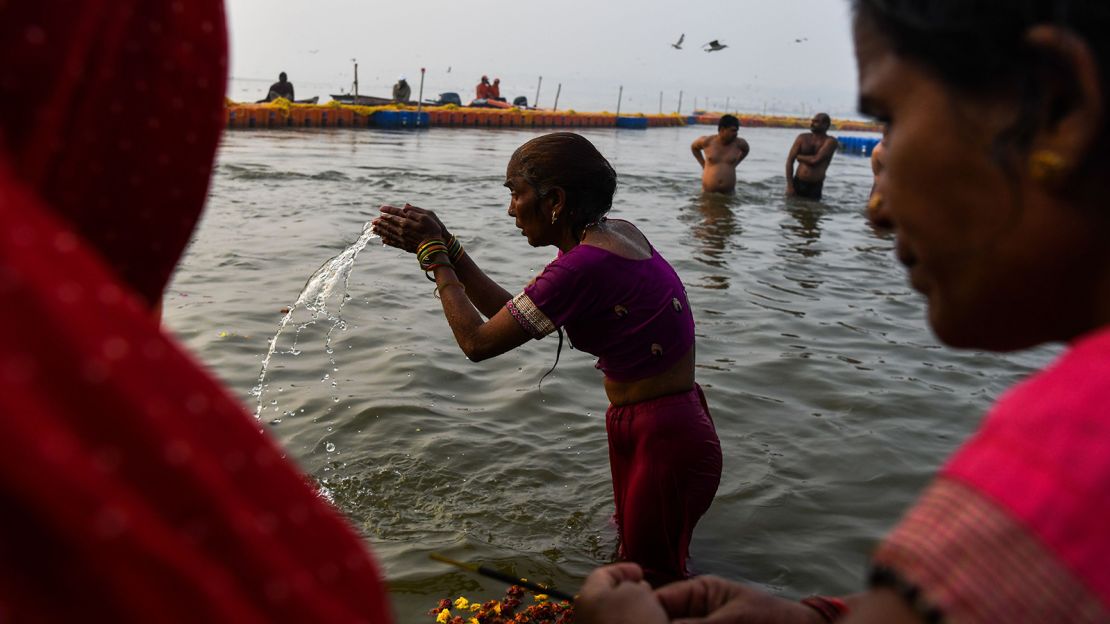 An Indian devotee takes a dip on the banks of the Triveni Sangam, the confluence of the Ganges, Yamuna and mythical Saraswati rivers. 