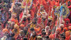 Indian devotees shower flower petals on Hindu holy men during a religious procession towards the Sangam area during the 'royal entry' for the upcoming Kumbh Mela festival in Allahabad on January 2, 2019. - The festival attracts millions of Hindu pilgrims to the sacred confluence of the Yamuna and Ganges rivers over 49 days between January 15 and March 4. (Photo by SANJAY KANOJIA / AFP)        (Photo credit should read SANJAY KANOJIA/AFP/Getty Images)