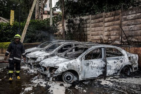 Burned cars are seen at the site of an explosion at the DusitD2 Hotel.