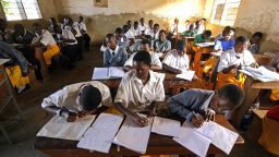 Pupils at Saint Denis Ssebugwawo Secondary School in the Kampala suburb of Ggaba take notes on 23 March 2007.