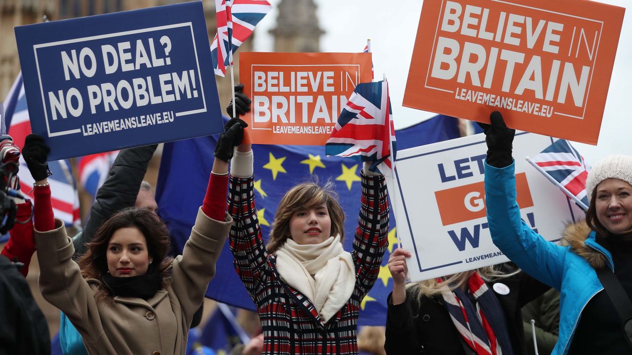 Pro-Brexit supporters hold up placards outside the UK Parliament as MPs debated.