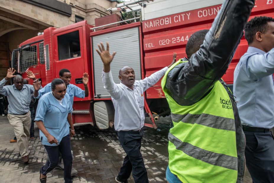 People put their hands up after being evacuated. 